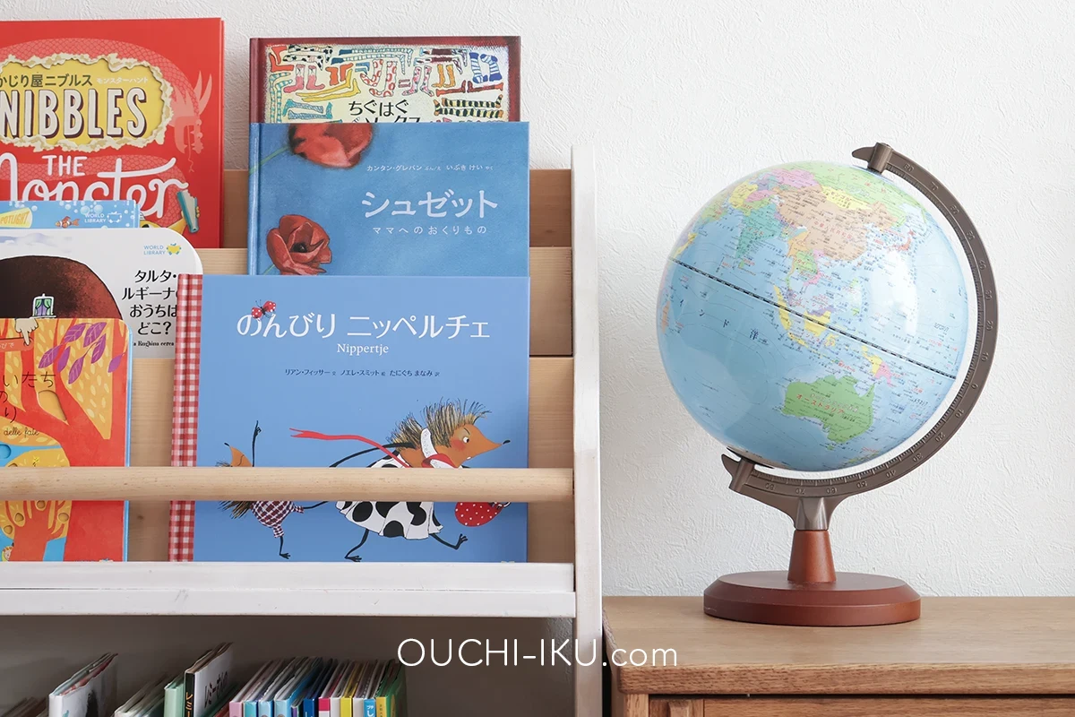 ワールドライブラリーの絵本を並べた絵本棚と地球儀